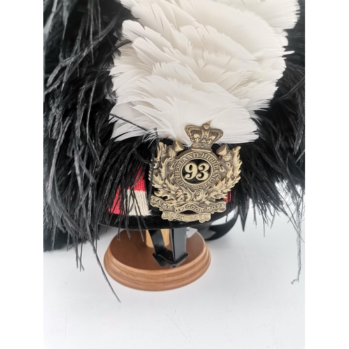 285 - A 93rd Sutherland Highlanders Regiment feather bonnet, with brass cap badge and white hackle, on woo... 