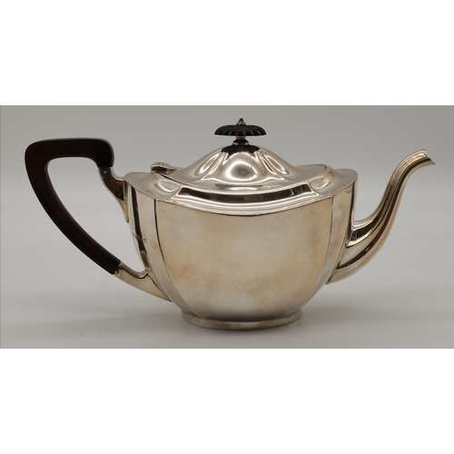 412 - A George V silver teapot by Barker Brothers Silver Ltd, Birmingham 1930, panelled oval, with shaped ... 