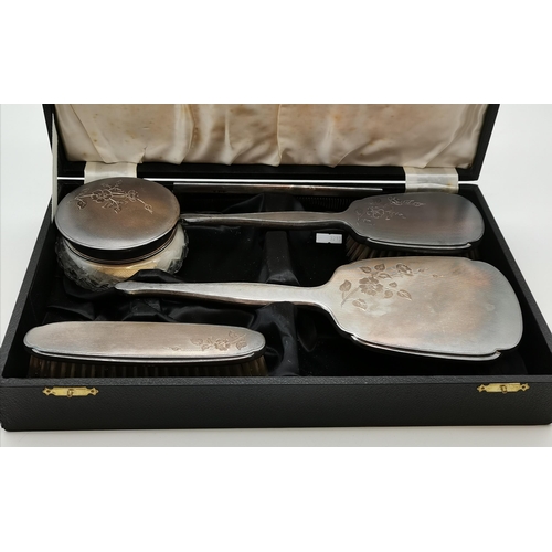 463A - An Elizabeth II silver five-piece dressing table set by Adie Brothers Ltd, Birmingham 1955, 1956 and... 