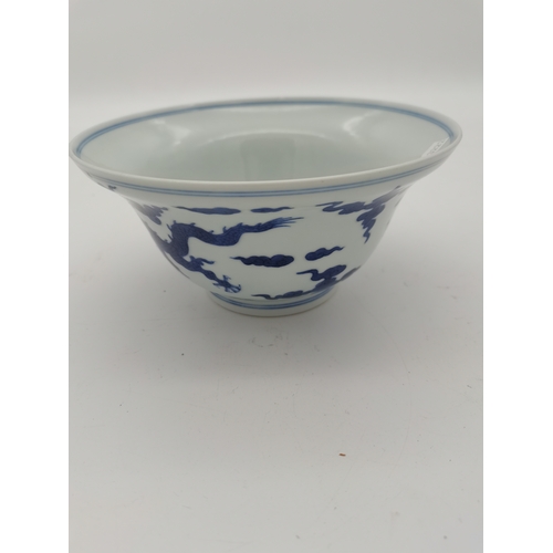 212 - A Chinese Qianlong porcelain blue and white bowl, 1800s, decorated with five-toed dragons to the ext... 