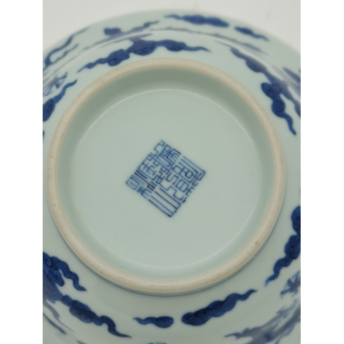 212 - A Chinese Qianlong porcelain blue and white bowl, 1800s, decorated with five-toed dragons to the ext... 