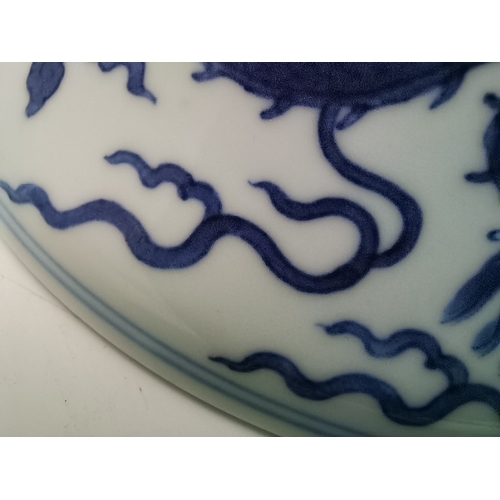 212 - A Chinese Qianlong porcelain blue and white bowl, 1800s, decorated with five-toed dragons to the ext... 