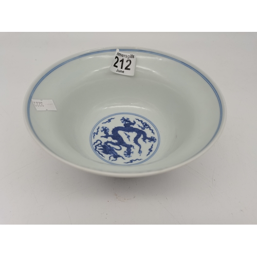 212 - A Chinese Qianlong porcelain blue and white bowl, 1800s, decorated with five-toed dragons to the ext... 