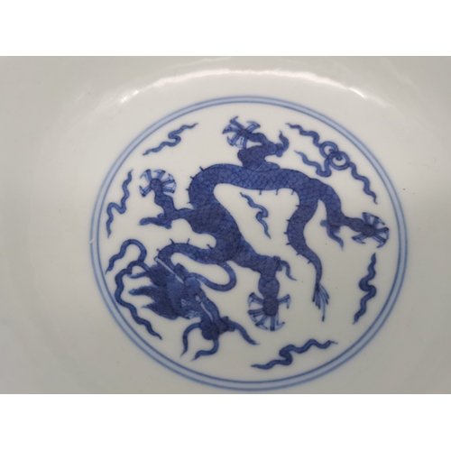 212 - A Chinese Qianlong porcelain blue and white bowl, 1800s, decorated with five-toed dragons to the ext... 