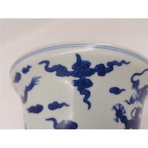 212 - A Chinese Qianlong porcelain blue and white bowl, 1800s, decorated with five-toed dragons to the ext... 