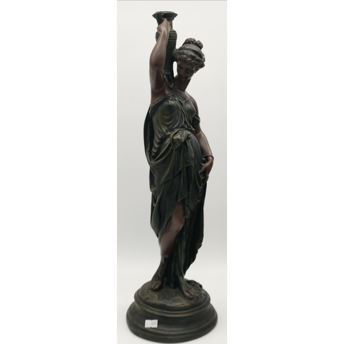 22 - Two figural sculptures, the first a classical female with a vessel on her shoulder; the second a bus... 