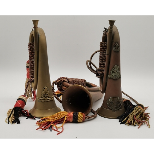 32 - Three military duty bugles with cording, late 19th/early 20th Century, comprising a copper and brass... 