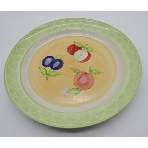 41 - A Royal Worcester 'Evesham Orchard' charger, decorated with fruits. 42.5cm diameter