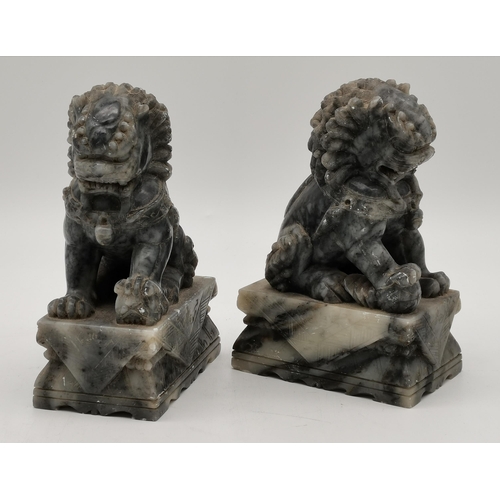 47 - A pair of Chinese soapstone carved Fu dogs, 20th Century. (2) 18cm high