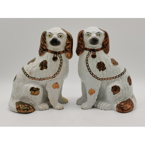 61 - Two pairs of Staffordshire spaniel dogs, one pair white with gilt detail, the other white with green... 