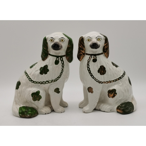 61 - Two pairs of Staffordshire spaniel dogs, one pair white with gilt detail, the other white with green... 