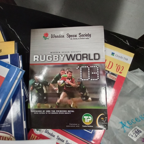 1286 - A set of Rugby World Wooden Spoon Society books, some signed by Gareth Chilcott, Dickie Bird, Ian Ro... 