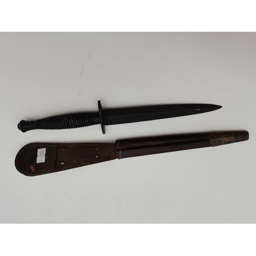 33 - A Fairbairn–Sykes British Commando knife, the blade painted black, with leather sheath. 28.5cm long ... 