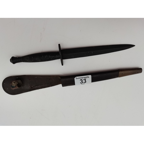 33 - A Fairbairn–Sykes British Commando knife, the blade painted black, with leather sheath. 28.5cm long ... 