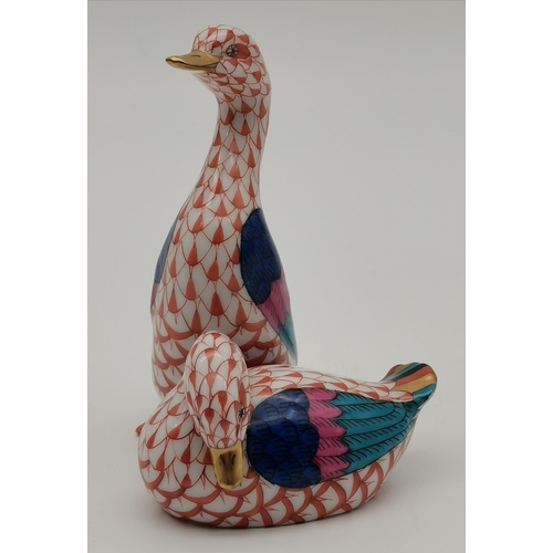 106 - A Herend porcelain penguin, decorated in red and white, with blue/purple wings and gold beak, on a s... 