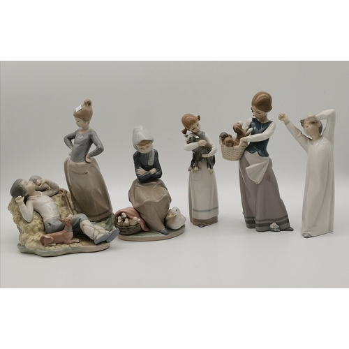 114 - A collection of five Lladro figures, including girl carrying a lamb, and woman holding a basket of p... 