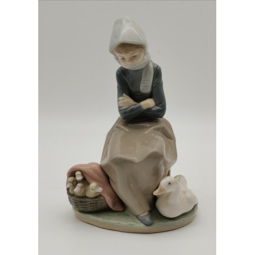 114 - A collection of five Lladro figures, including girl carrying a lamb, and woman holding a basket of p... 