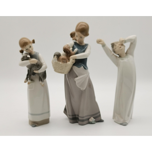 114 - A collection of five Lladro figures, including girl carrying a lamb, and woman holding a basket of p... 