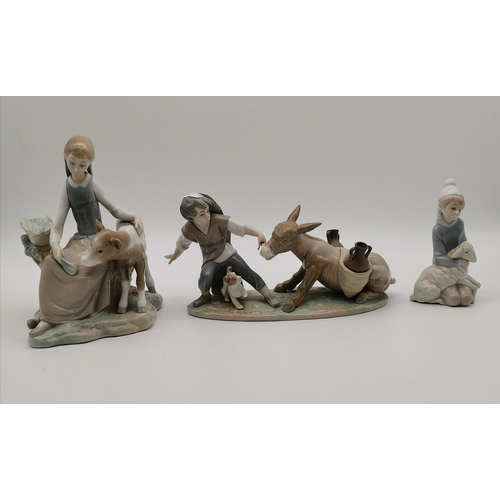 115 - Three Lladro figure and animal groups, comprising girl seated with calf, girl kneeling with lamb, an... 