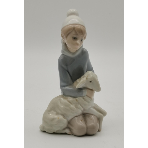 115 - Three Lladro figure and animal groups, comprising girl seated with calf, girl kneeling with lamb, an... 