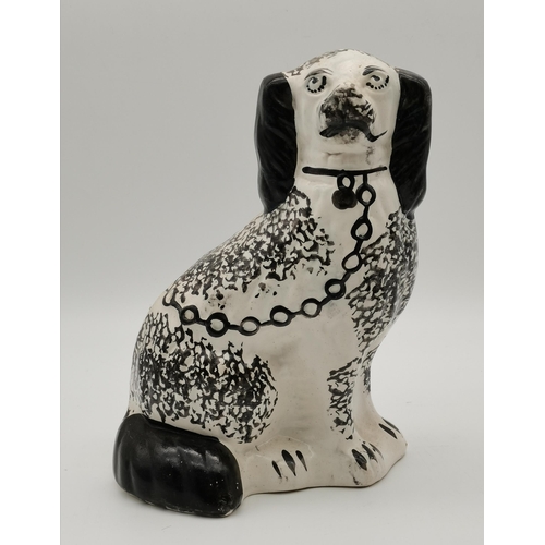 120 - A pair of Midwest Stoneware Rockingham treacle glazed Spaniels, c.1900; together with a black and wh... 