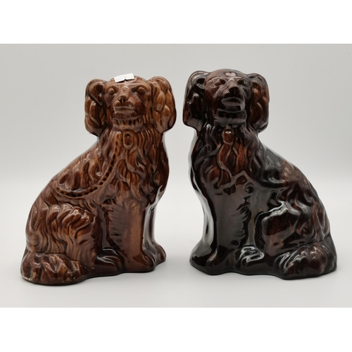 120 - A pair of Midwest Stoneware Rockingham treacle glazed Spaniels, c.1900; together with a black and wh... 