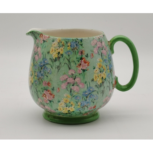 187 - A Shelley 'Melody' milk jug, the green patterned ground with multicoloured floral sprays, (a/f). 13.... 