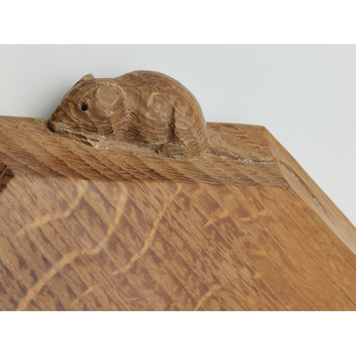 189 - Robert Thompson, a Mouseman oak breadboard, elongated octagonal, the surface lightly adzed, with car... 