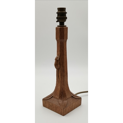 191 - Robert Thompson, a Mouseman oak table lamp, the octagonal column issuing from a square base with lea... 