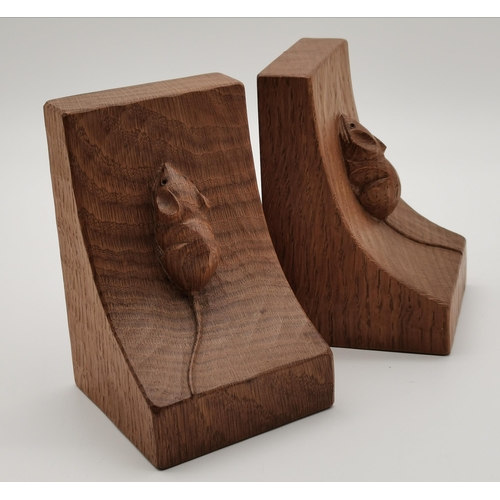 198 - Robert Thompson, a pair of Mouseman oak bookends, of typical dished form, each with carved mouse sig... 