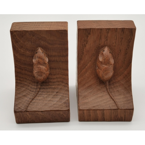 198 - Robert Thompson, a pair of Mouseman oak bookends, of typical dished form, each with carved mouse sig... 