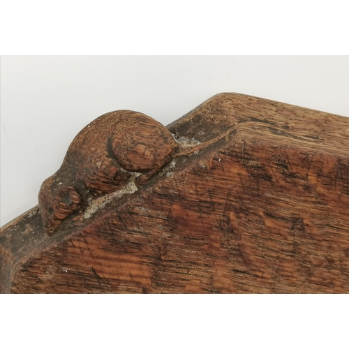 200 - Robert Thompson, a Mouseman oak breadboard, elongated octagonal, with carved mouse signature. 30.7cm... 