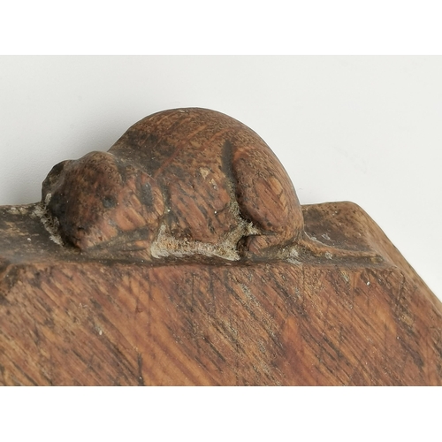 200 - Robert Thompson, a Mouseman oak breadboard, elongated octagonal, with carved mouse signature. 30.7cm... 