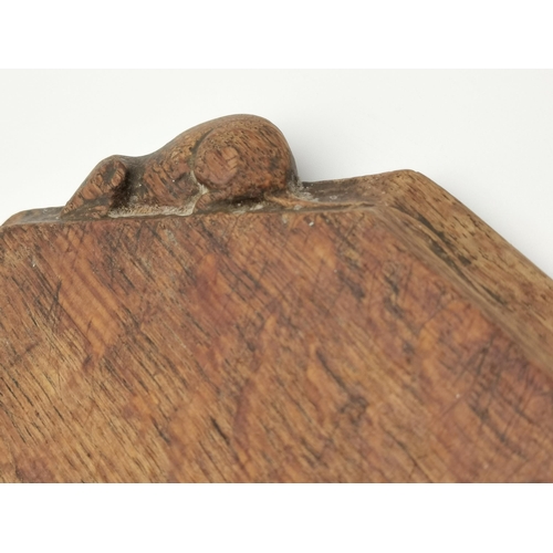 200 - Robert Thompson, a Mouseman oak breadboard, elongated octagonal, with carved mouse signature. 30.7cm... 