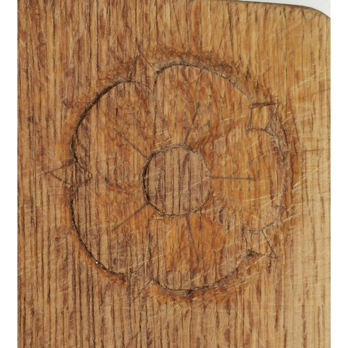 201 - A Yorkshire oak bread board, rounded rectangular, with recessed carved Tudor rose. 23.5cm by 30cm  (... 