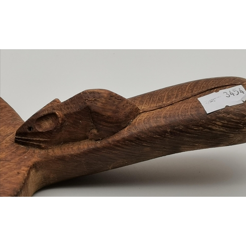 202 - Robert Thompson, a Mouseman oak cheese board, oval, with carved mouse signature to handle. 39cm long... 