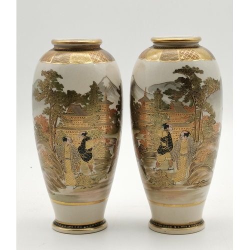 208 - A pair of Japanese Satsuma vases, decorated with figures before pagodas, in a mountain and lake land... 