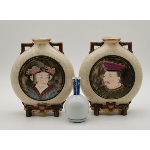 214 - A pair of Royal Worcester porcelain Japanese style moon flask vases, late 19th Century, with speckle... 