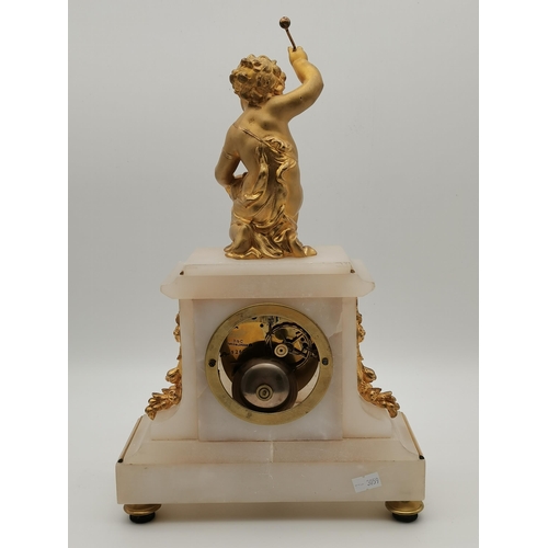 24 - A late 19th Century French mantel clock, the alabaster body surmounted by a gilt-metal putto playing... 