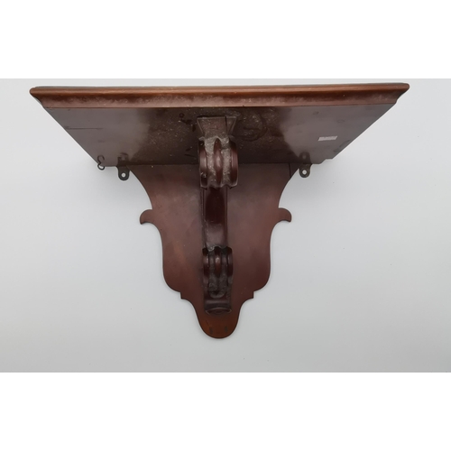 27 - A mahogany wall bracket, with C-scroll support. Approx. 29cm high, 37.5cm wide, 21cm deep