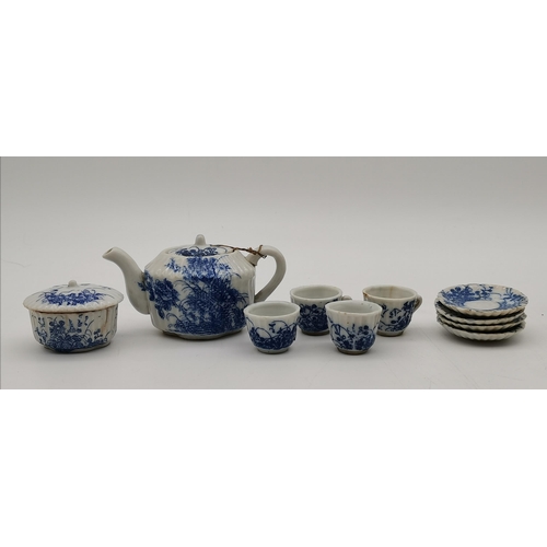 293 - Two dolls house miniature part-tea services, including one blue and white decorated comprising teapo... 