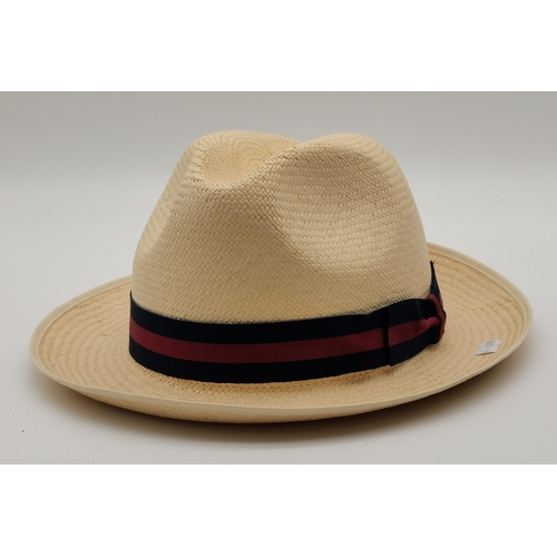 302 - A collection of four gent's hats, comprising a Panama with navy and burgundy ribbon, together with t... 