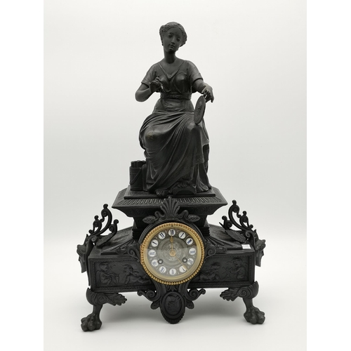 33 - A late 19th Century mantel clock surmounted with a seated female artist figure, cast with figural ma... 