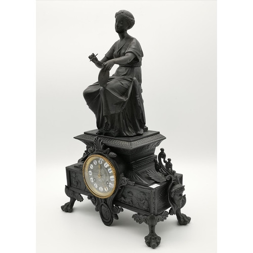 33 - A late 19th Century mantel clock surmounted with a seated female artist figure, cast with figural ma... 