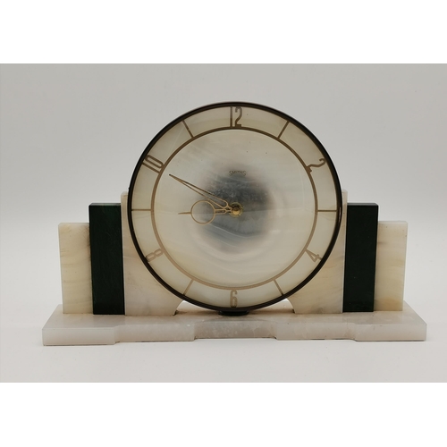 34 - An Art Deco onyx mantel clock, the circular dial signed SMITHS, with Arabic numerals at the even hou... 