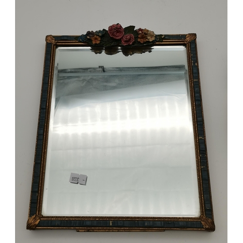 35 - Two floral encrusted mirrors, one wall-hanging, circular; the other rectangular with easel back. (2)... 