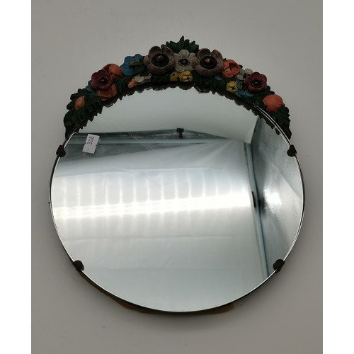 35 - Two floral encrusted mirrors, one wall-hanging, circular; the other rectangular with easel back. (2)... 