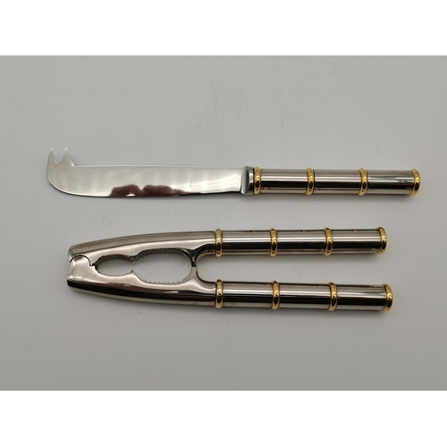 358 - Asprey: A cheese knife and nut-cracker set, with bi-metal 