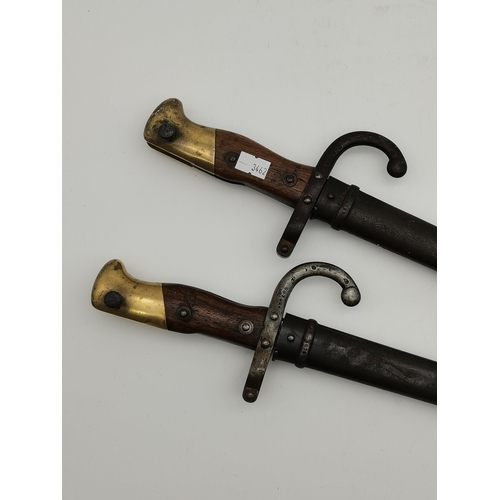 37 - Two French Gras bayonets, M1874, with steel scabbards, each signed to blade T-back 'Mre d'Armes de S... 