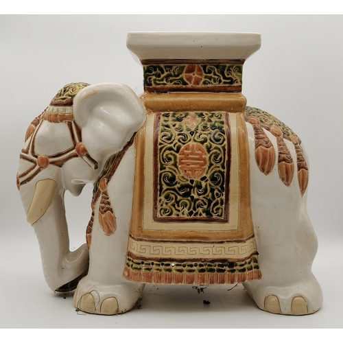 41 - A ceramic jardinière, the plant stand as an Asian elephant, cream, with green and brown decoration. ... 